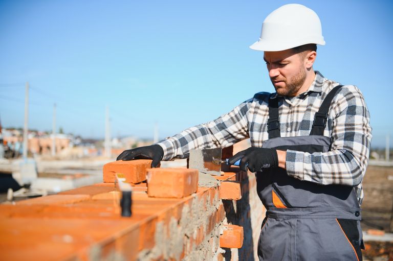Skilled mason laying brick on a wall — Steve Smith Masonry serving Newport and Lincoln County, Oregon