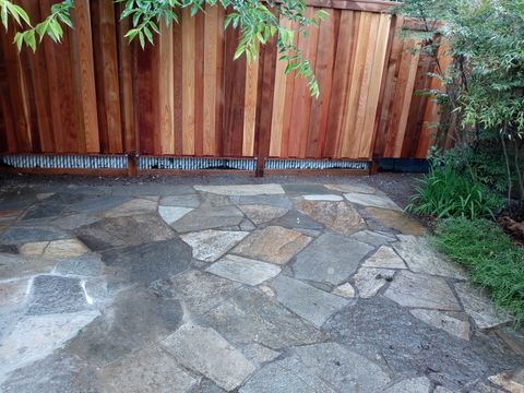 Flagstone patio masonry near a cedar fence in Lincoln County, Oregon